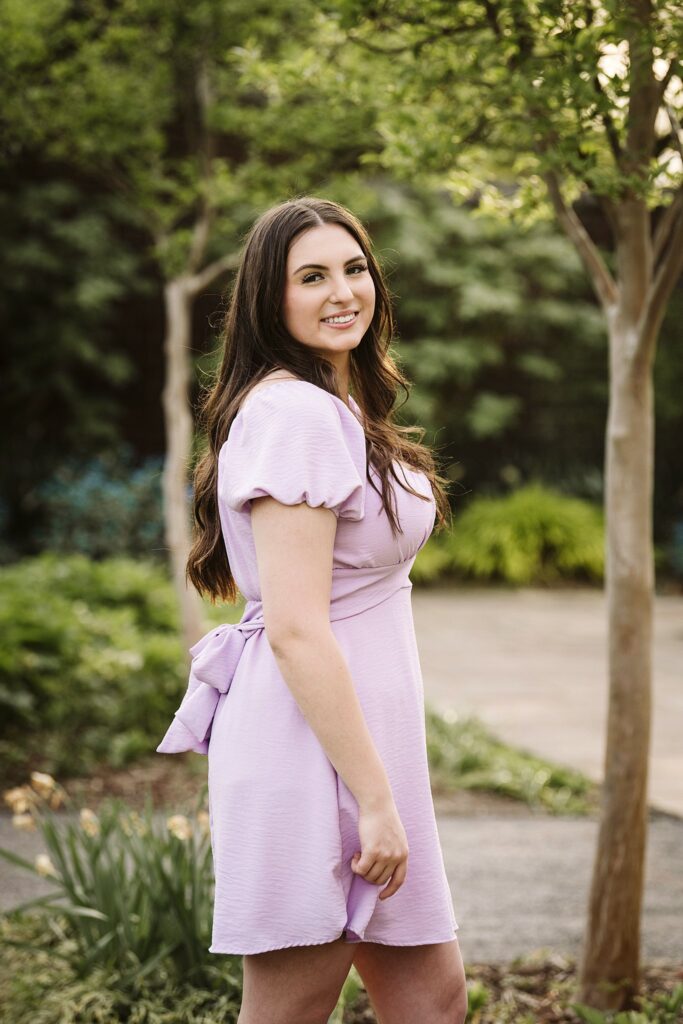 portrait of senior in flower garden at sunset