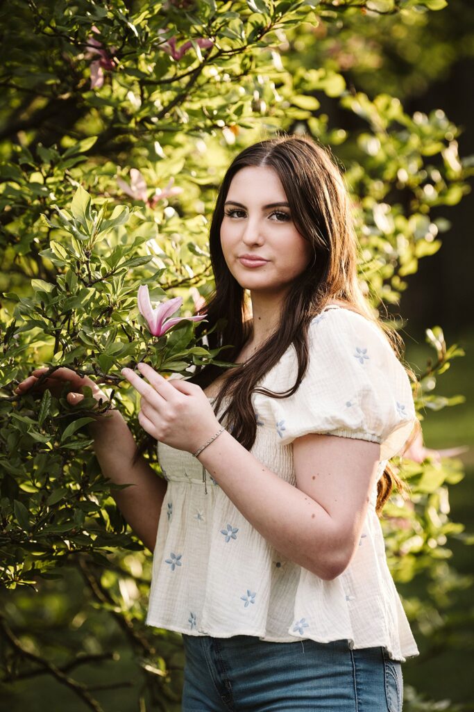 portrait of senior in flower garden at sunset