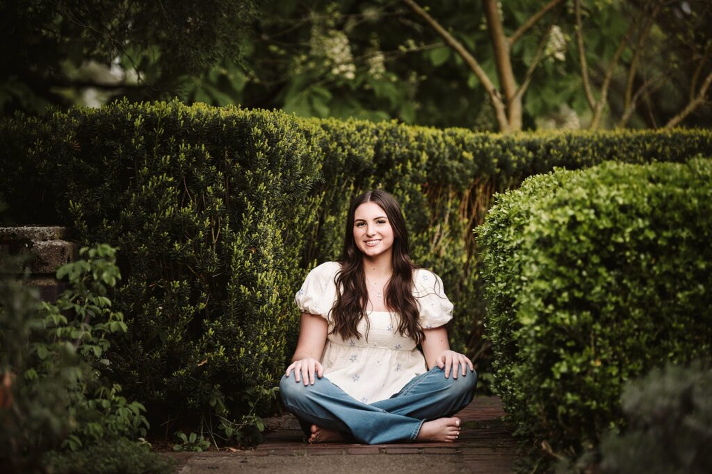 portrait of senior in flower garden at sunset