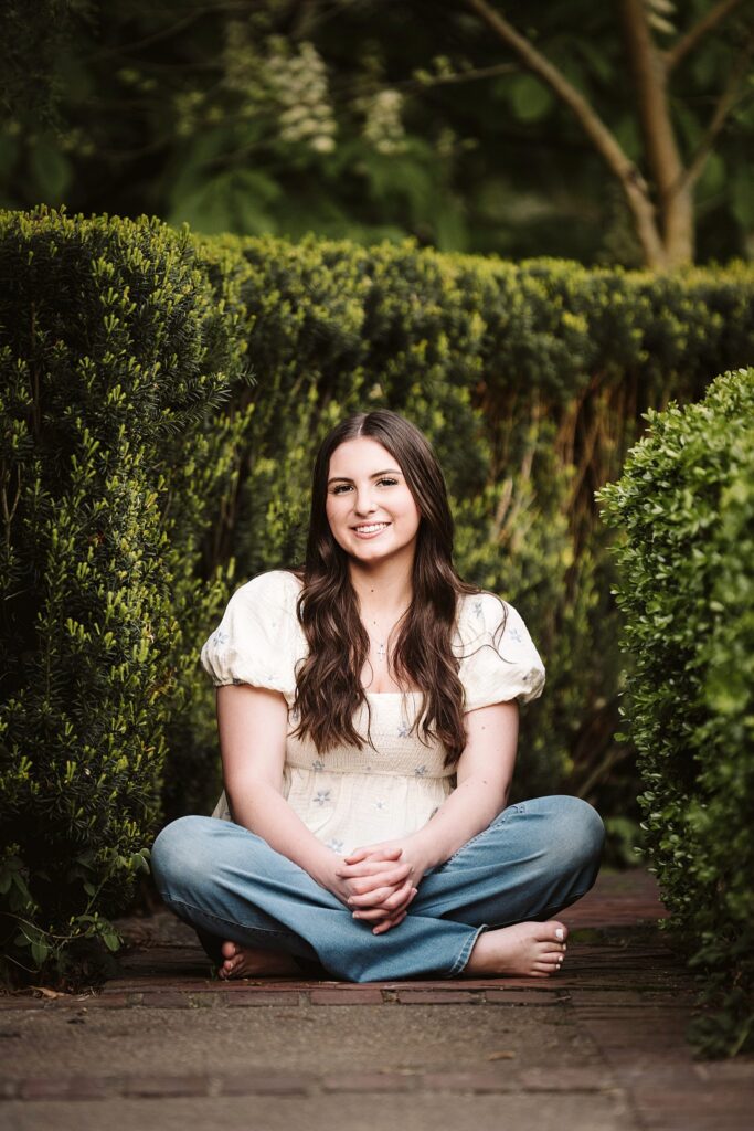 portrait of senior in flower garden at sunset