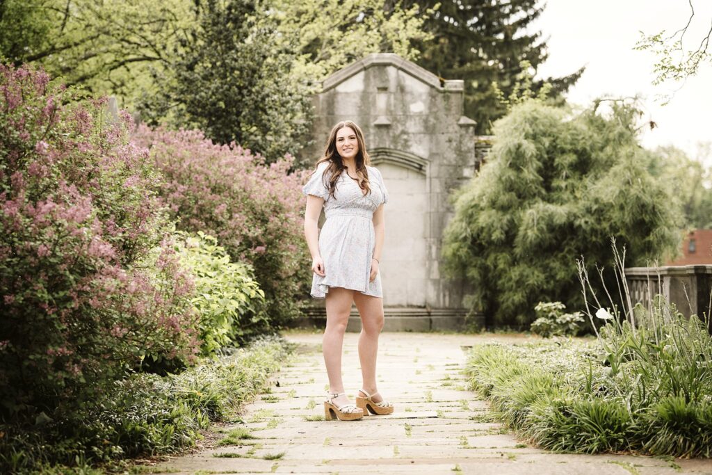 portrait of senior in flower garden at sunset