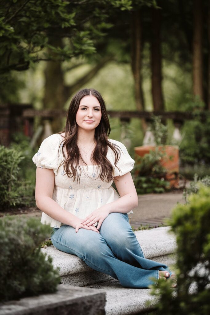 portrait of senior in flower garden at sunset