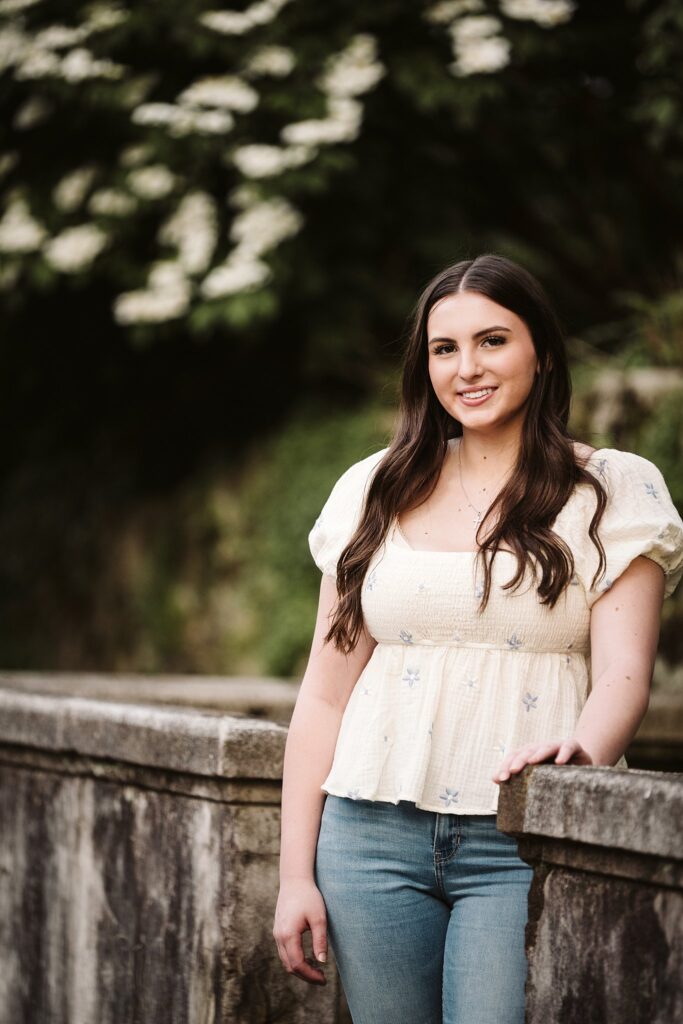 portrait of senior in flower garden at sunset