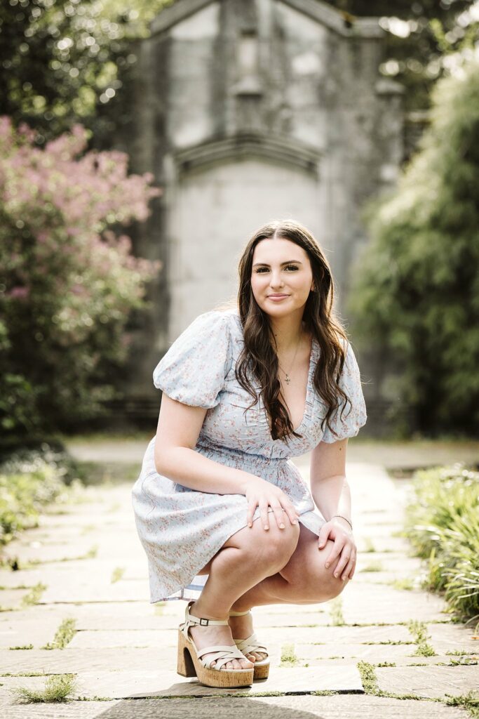 portrait of senior in flower garden at sunset