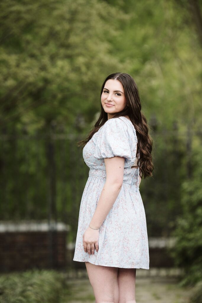 portrait of senior in flower garden at sunset