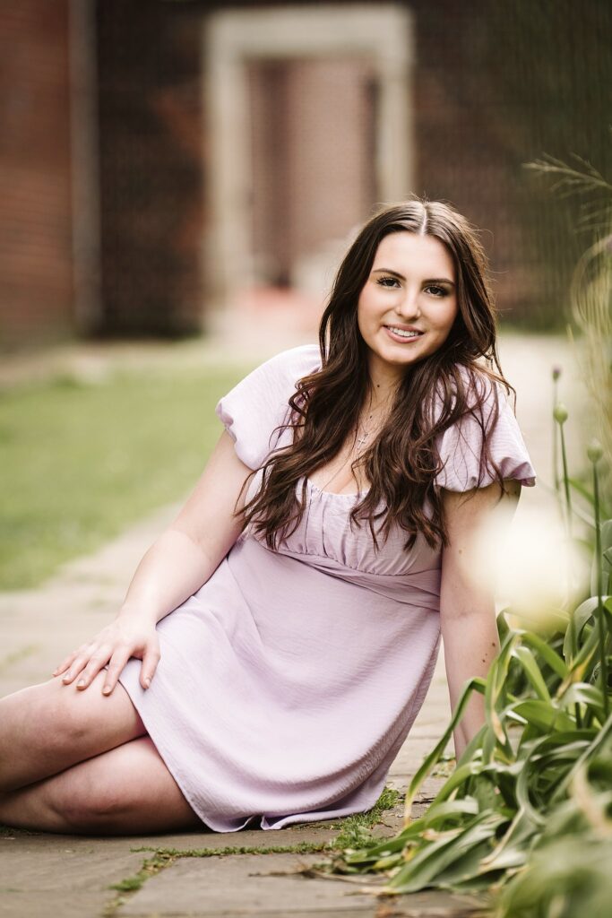 portrait of senior in flower garden at sunset