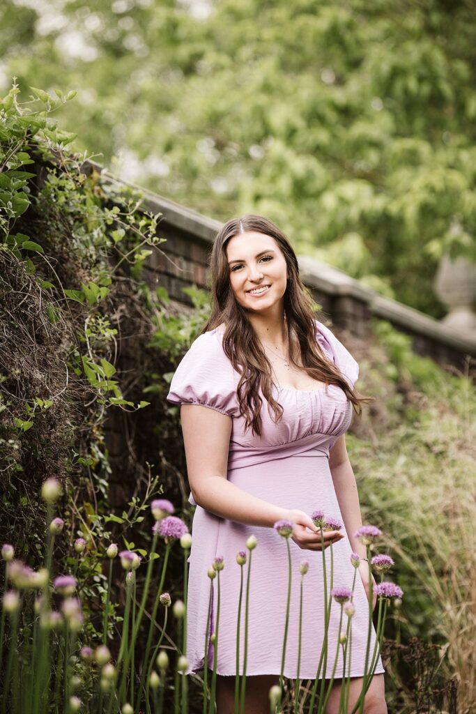 portrait of senior in flower garden at sunset