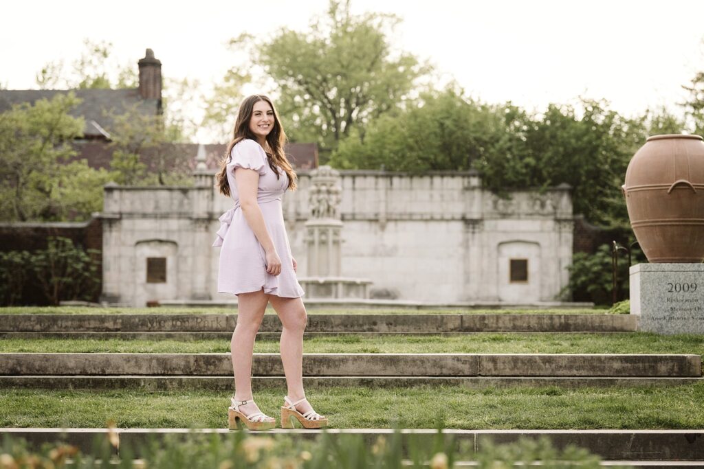 portrait of senior in flower garden at sunset