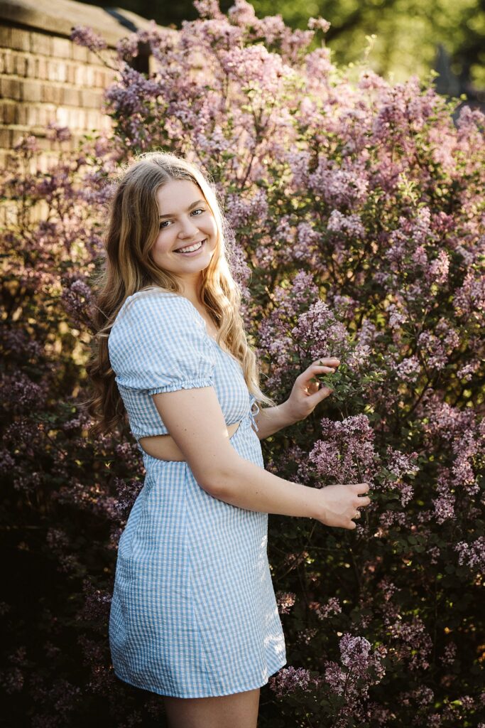 portrait of senior in flower garden at sunset