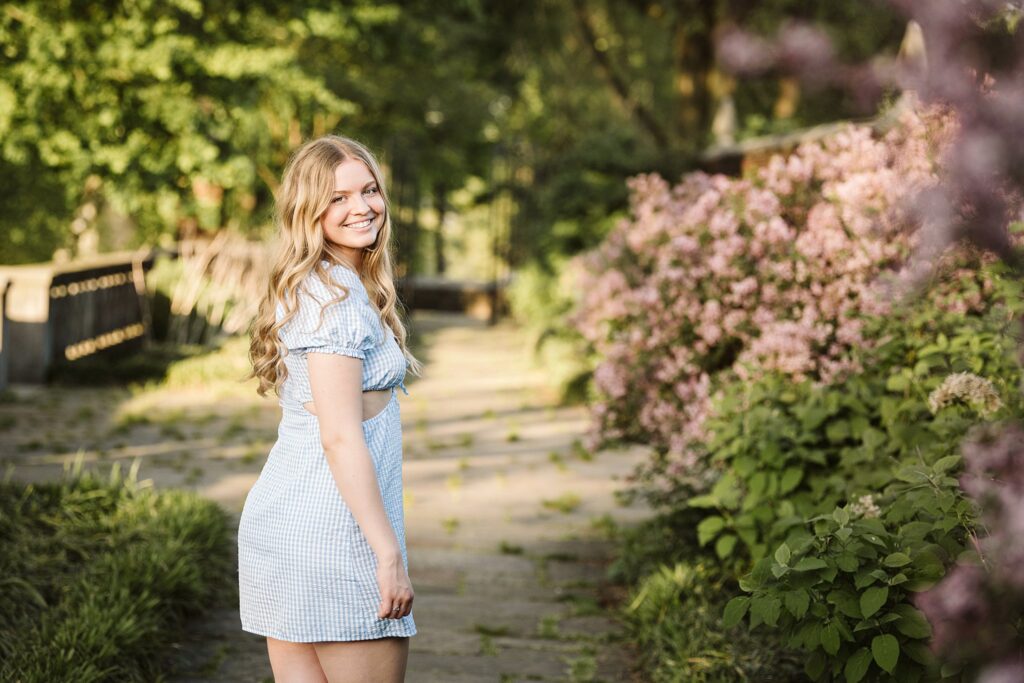 portrait of senior in flower garden at sunset