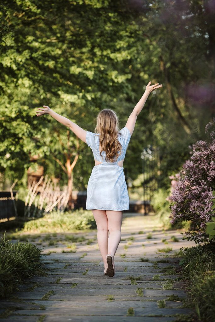 portrait of senior in flower garden at sunset