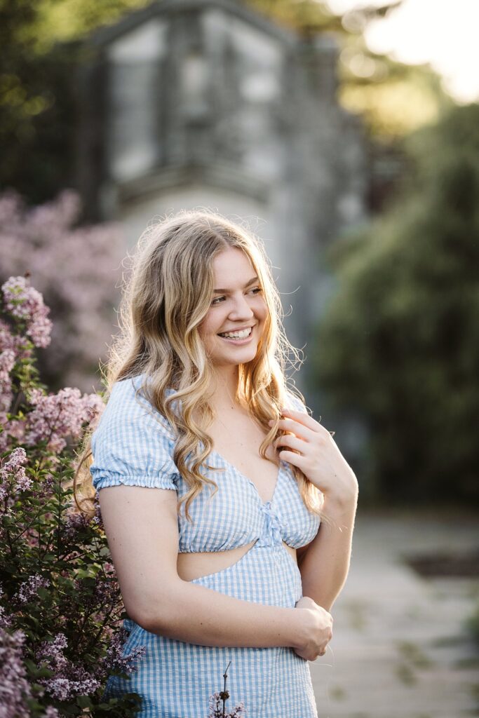 portrait of senior in flower garden at sunset