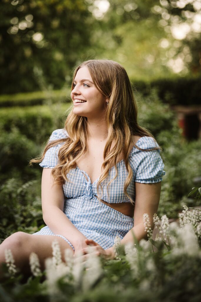 portrait of senior in flower garden at sunset