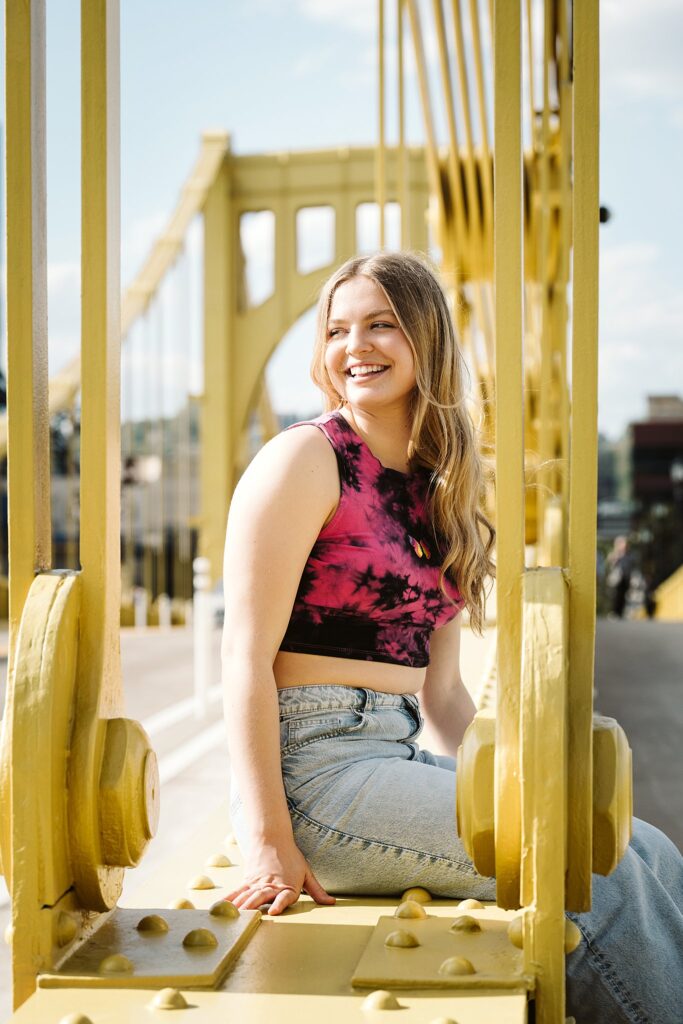 senior portrait on Roberto Clemente bridge in Pittsburgh