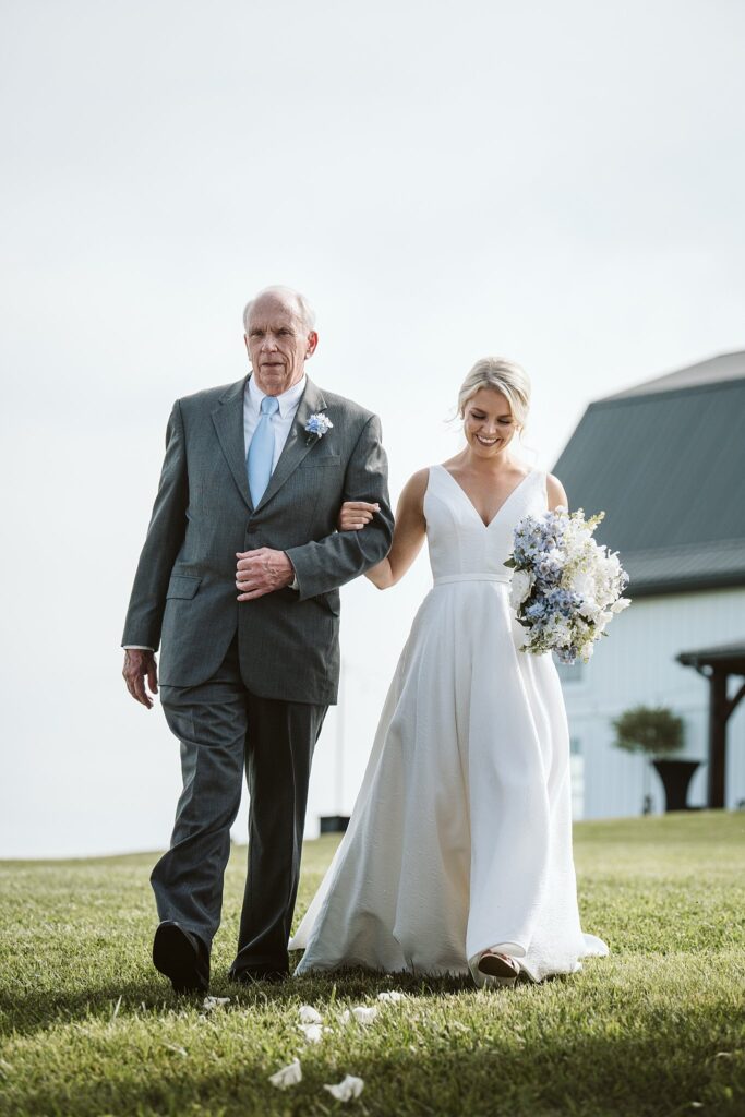 bride and her father enter wedding ceremony at The Grayson House