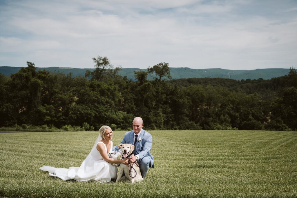 bride and groom with her dog on their wedding day