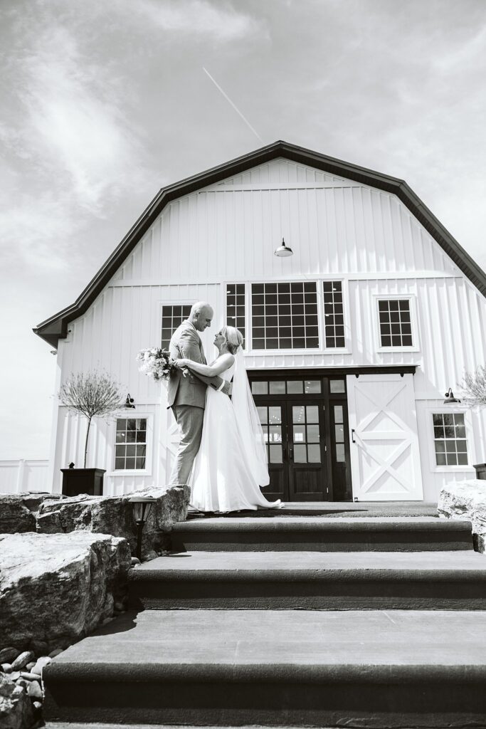 black and white portrait of bride and groom outside The Grayson House