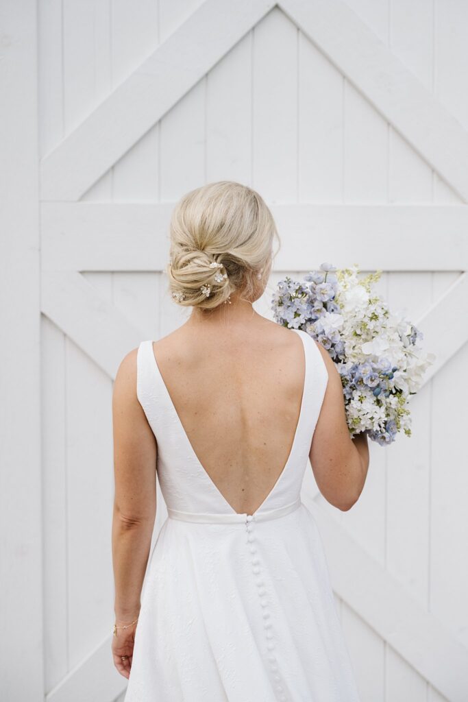 Bride's hairstyle in front of white barn door