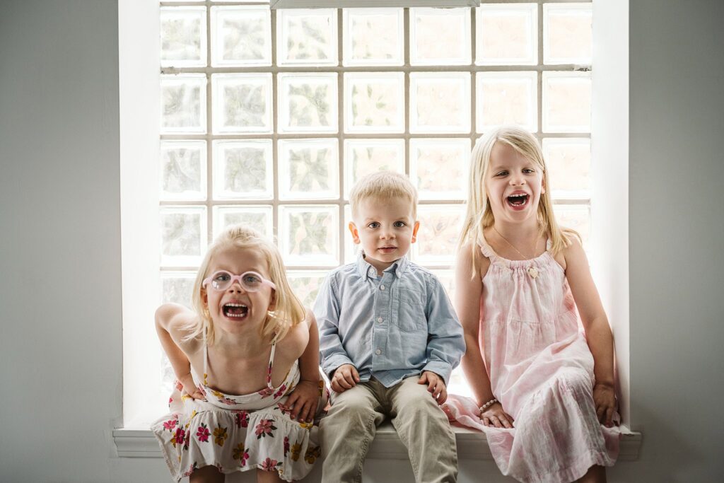 big siblings having fun during a newborn photoshoot