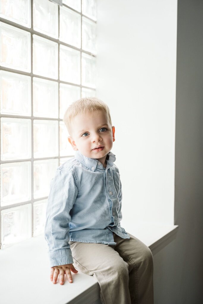 child sitting in a window nook