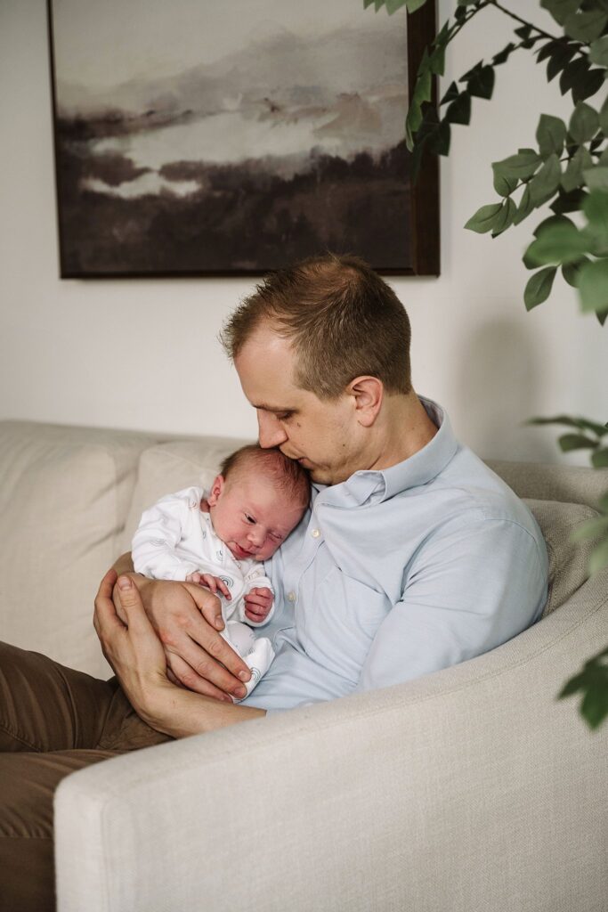 father holding newborn baby