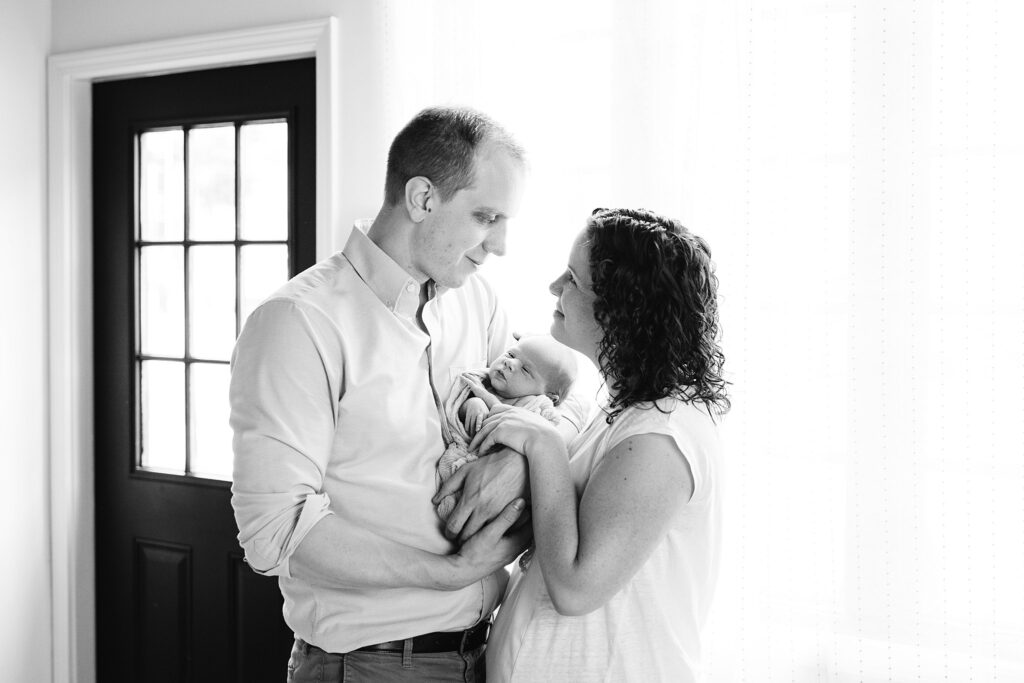 loving parents holding newborn baby