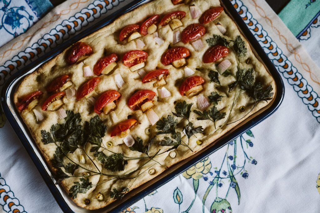 focaccia bread decorated with tomatoes