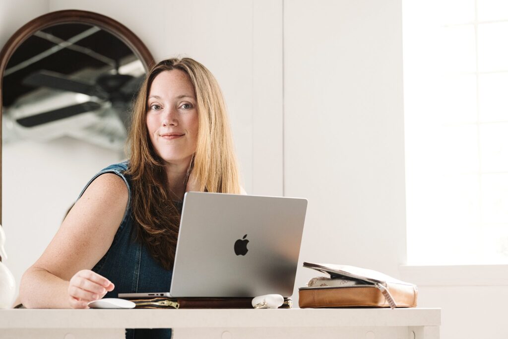 Pittsburgh Photographer, Laura Mares, working at laptop in studio