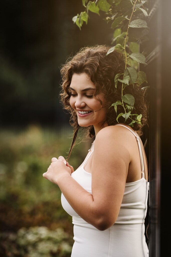 senior portrait in a flower garden at sunset