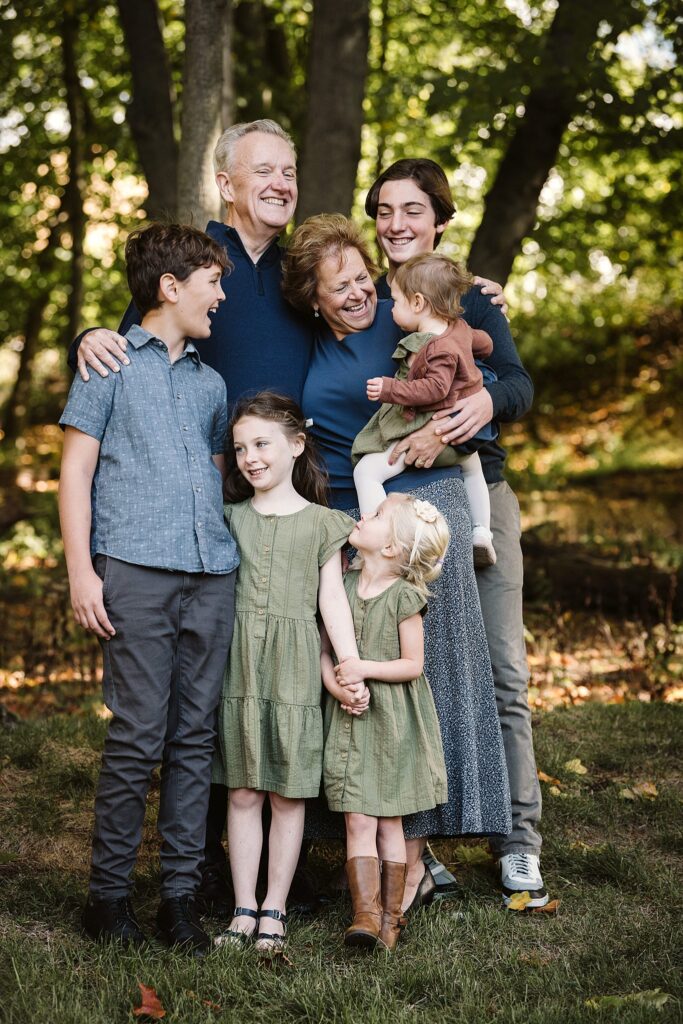 grandparents with grandchildren captured during extended family session in family's backyard