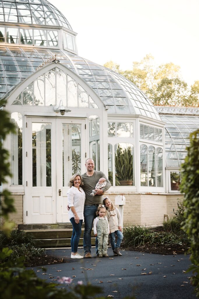 family of five fall portrait at greenhouse