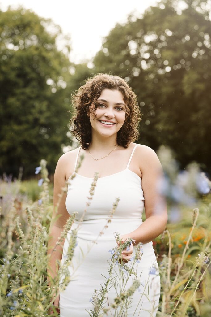 portrait of senior girl wearing a dress in a garden near Pittsburgh, PA