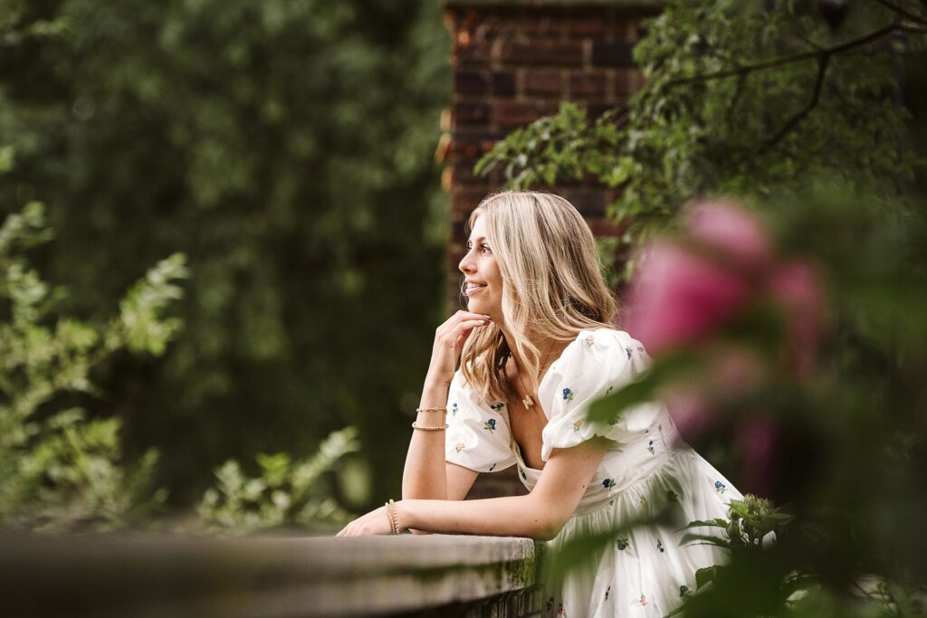 portrait of senior girl wearing a lace dress in a garden near Pittsburgh, PA