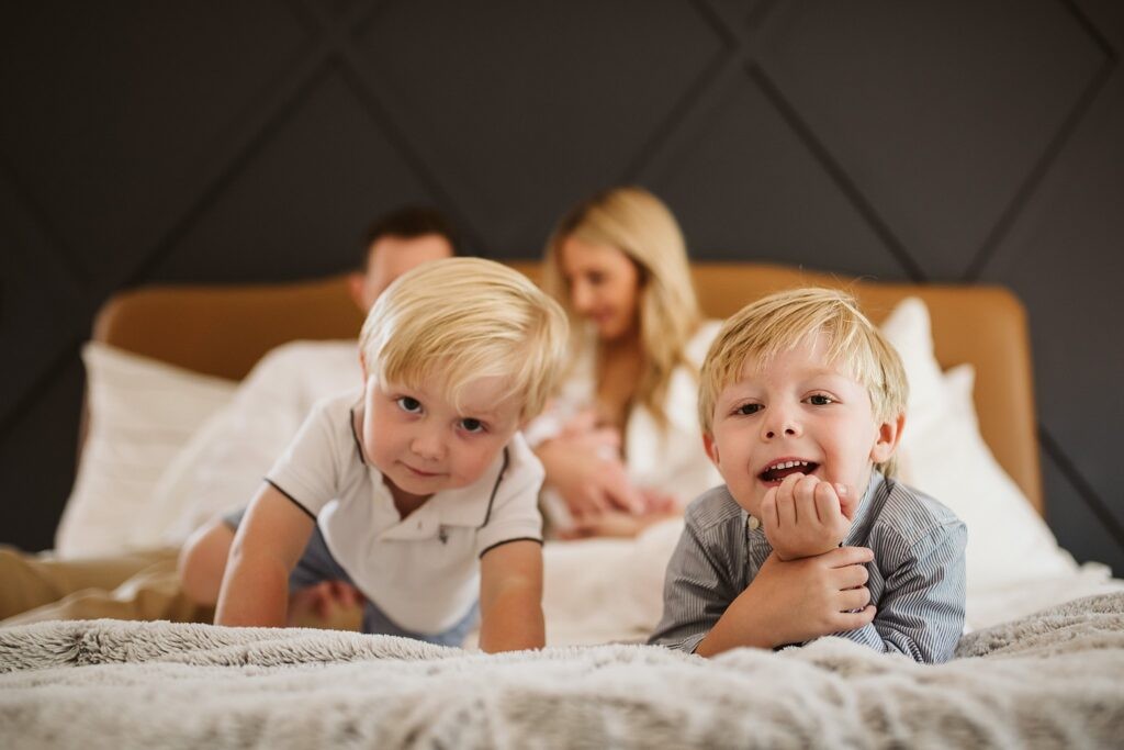 lifestyle portrait of a family in bed