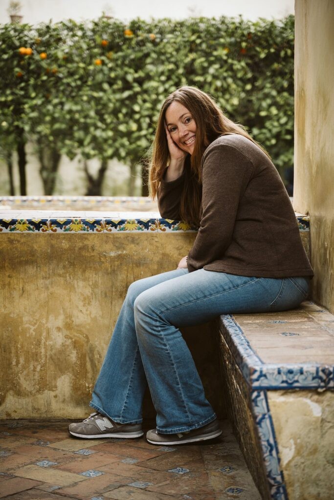 Laura Mares sitting in courtyard, Royal Alcazar, Seville, Spain