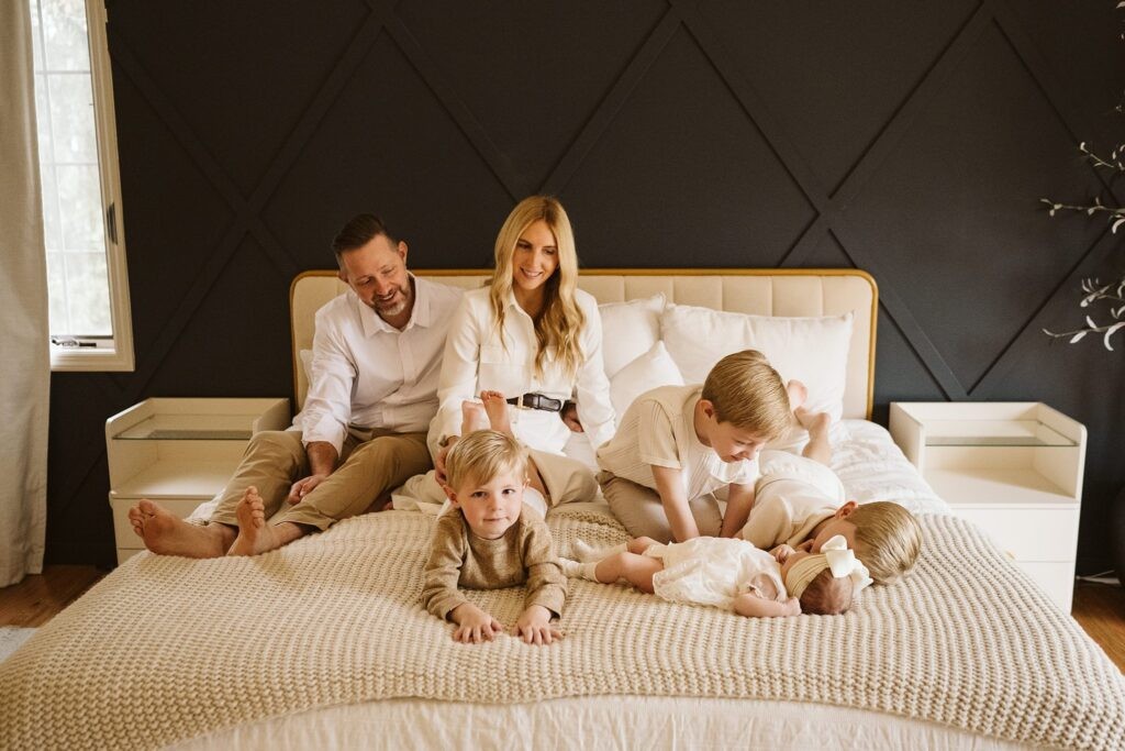 newborn lifestyle portrait of family on a bed