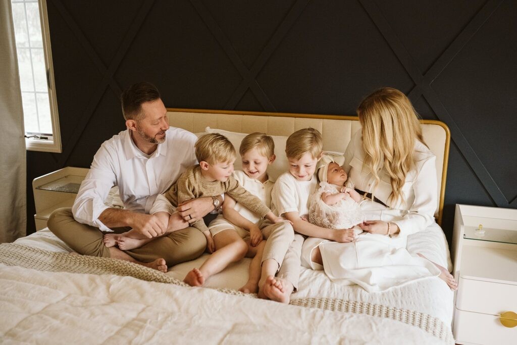newborn lifestyle portrait of family on a bed