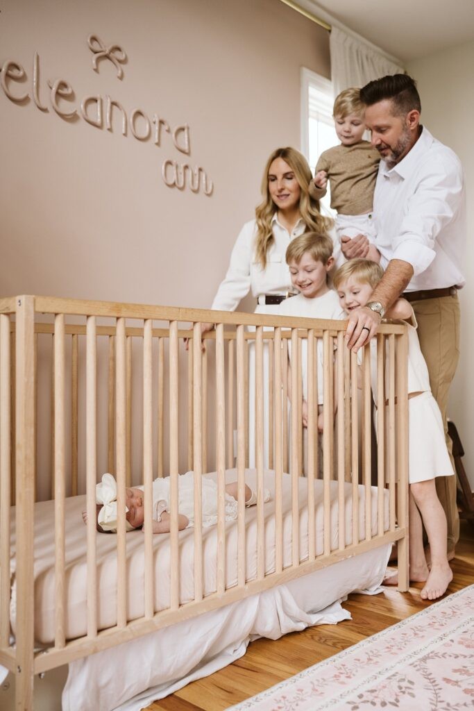 family around crib with newborn