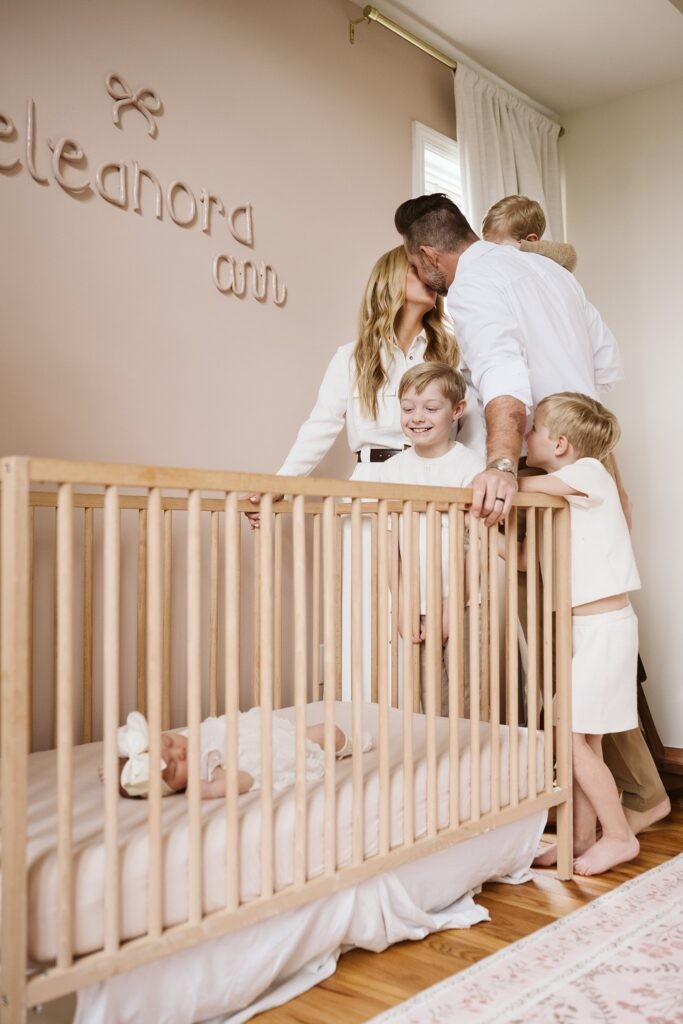 family around crib with newborn
