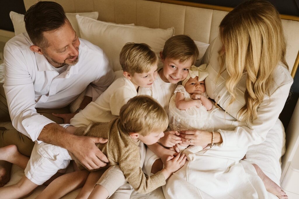 newborn lifestyle portrait of family on a bed