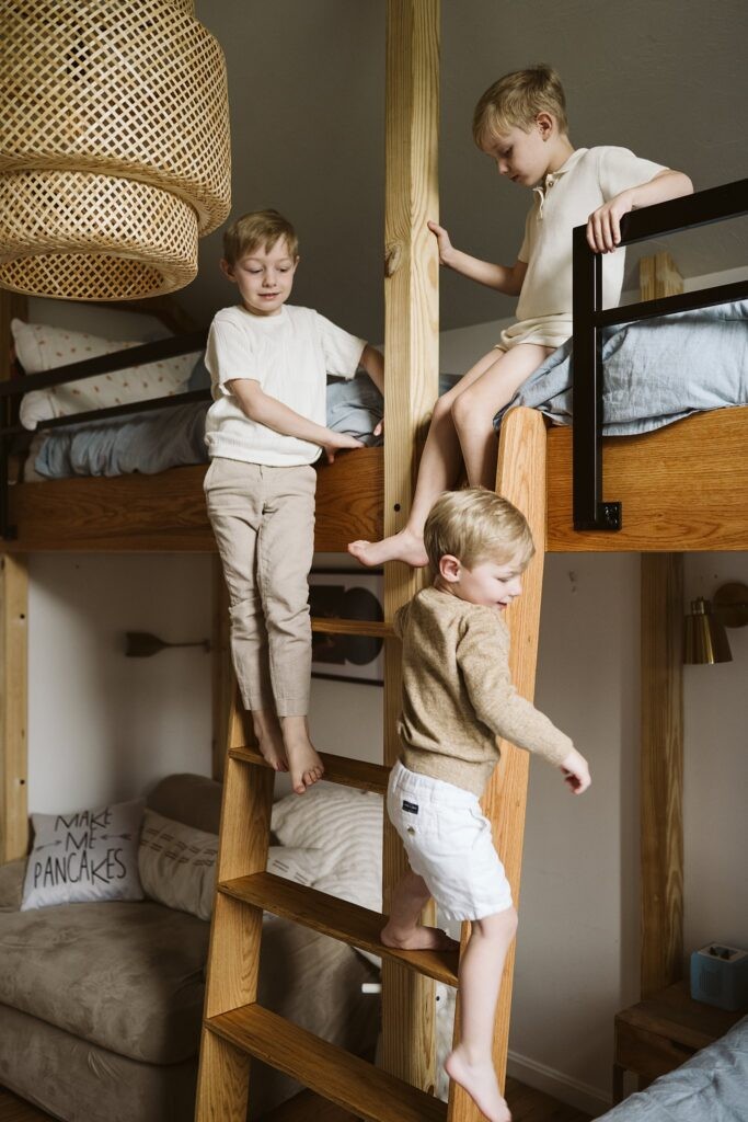 boys climbing on bunk bed during family lifestyle session