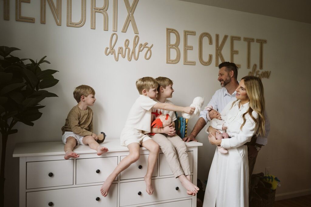 family in boy's room during newborn lifestyle photo shoot