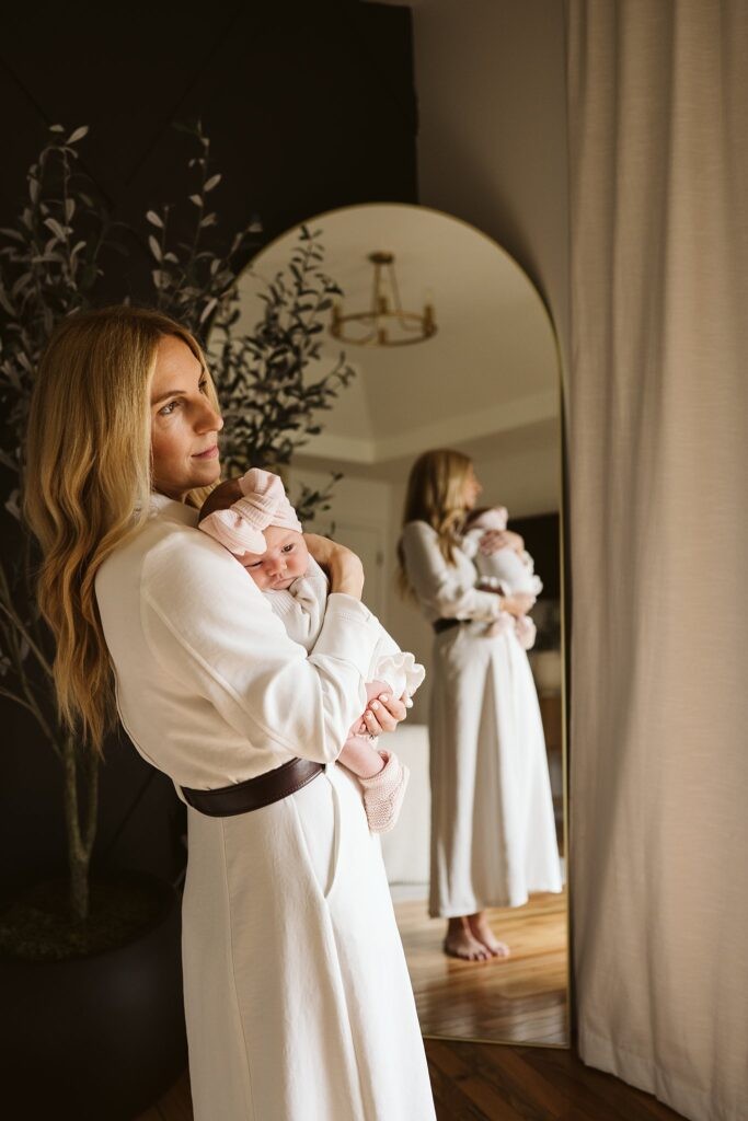 mother and newborn lifestyle portrait with reflection in mirror
