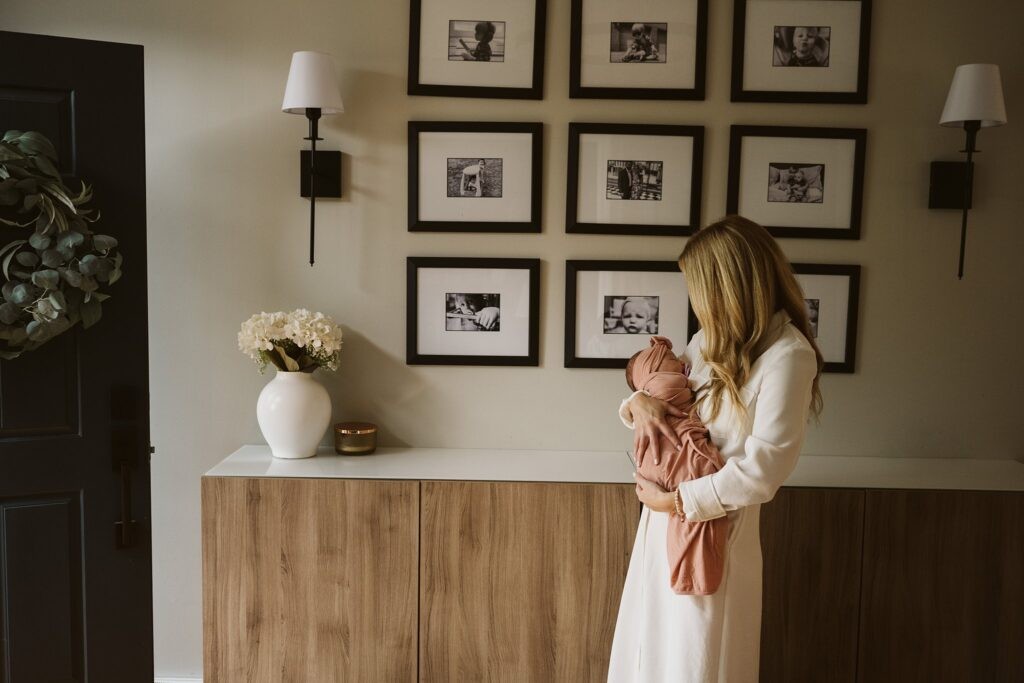 mom holding newborn lifestyle portrait