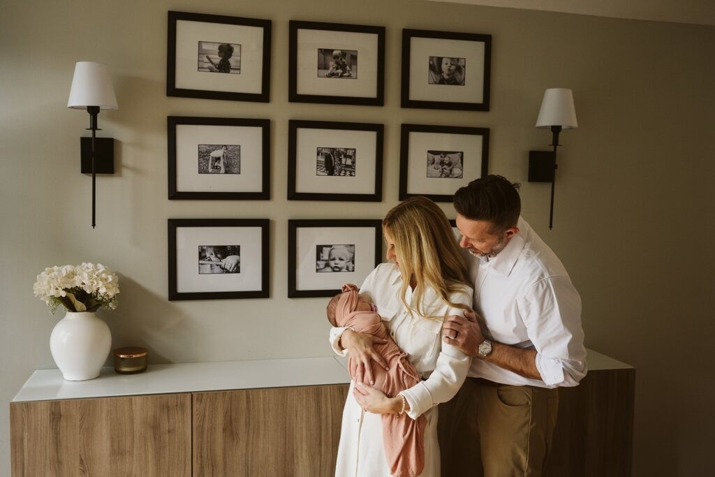 parents holding newborn lifestyle portrait