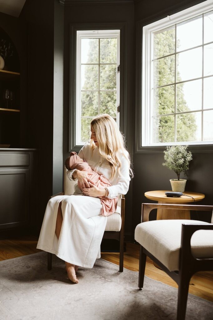 mom holding newborn lifestyle portrait