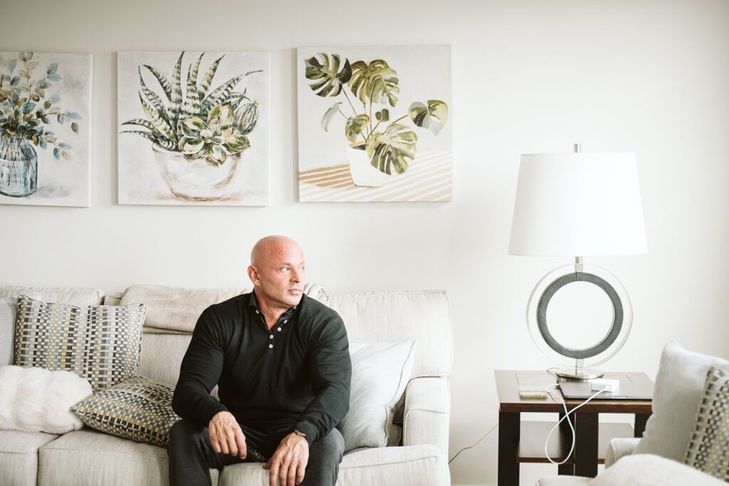 editorial portrait of man sitting in the living room