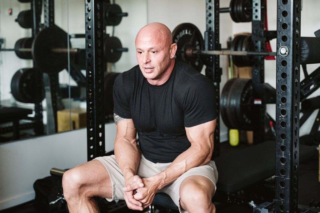 editorial portrait of man at kitchen counter with cat