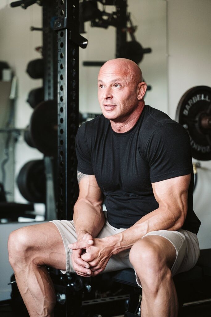 editorial portrait of man at kitchen counter with cat