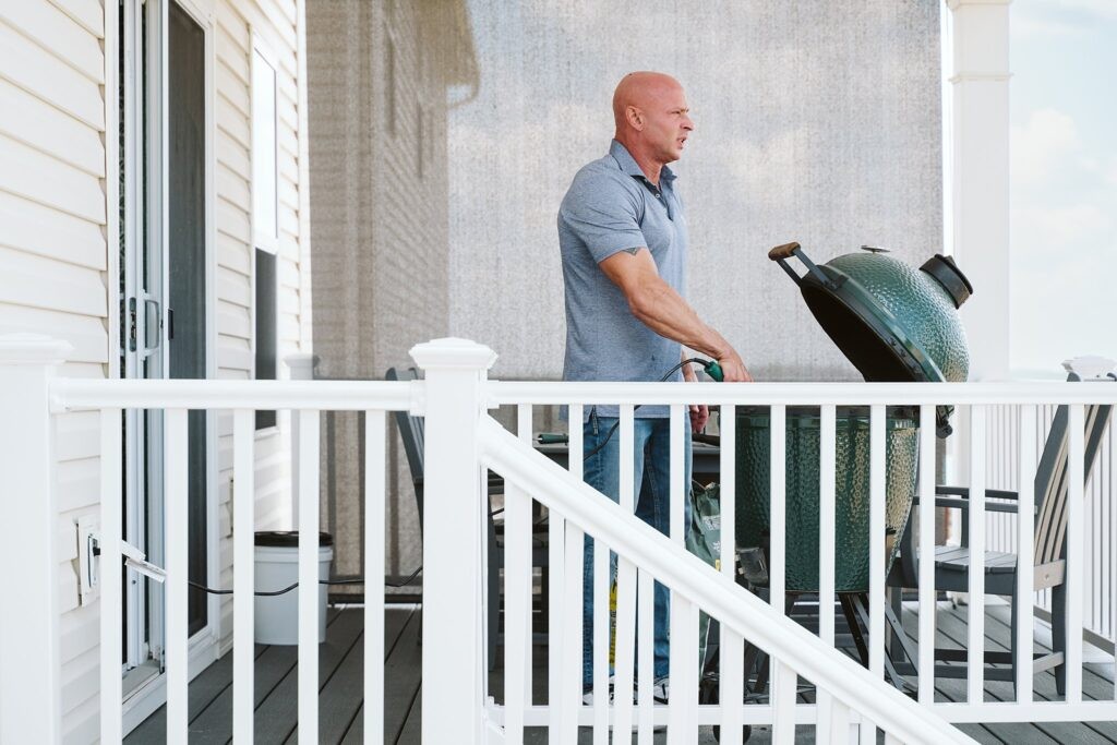 editorial portrait of man grilling outside